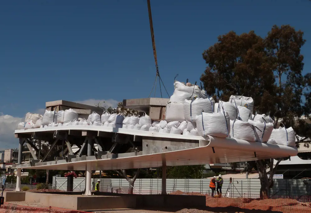 Large white bags on top of a structure being constructed. 