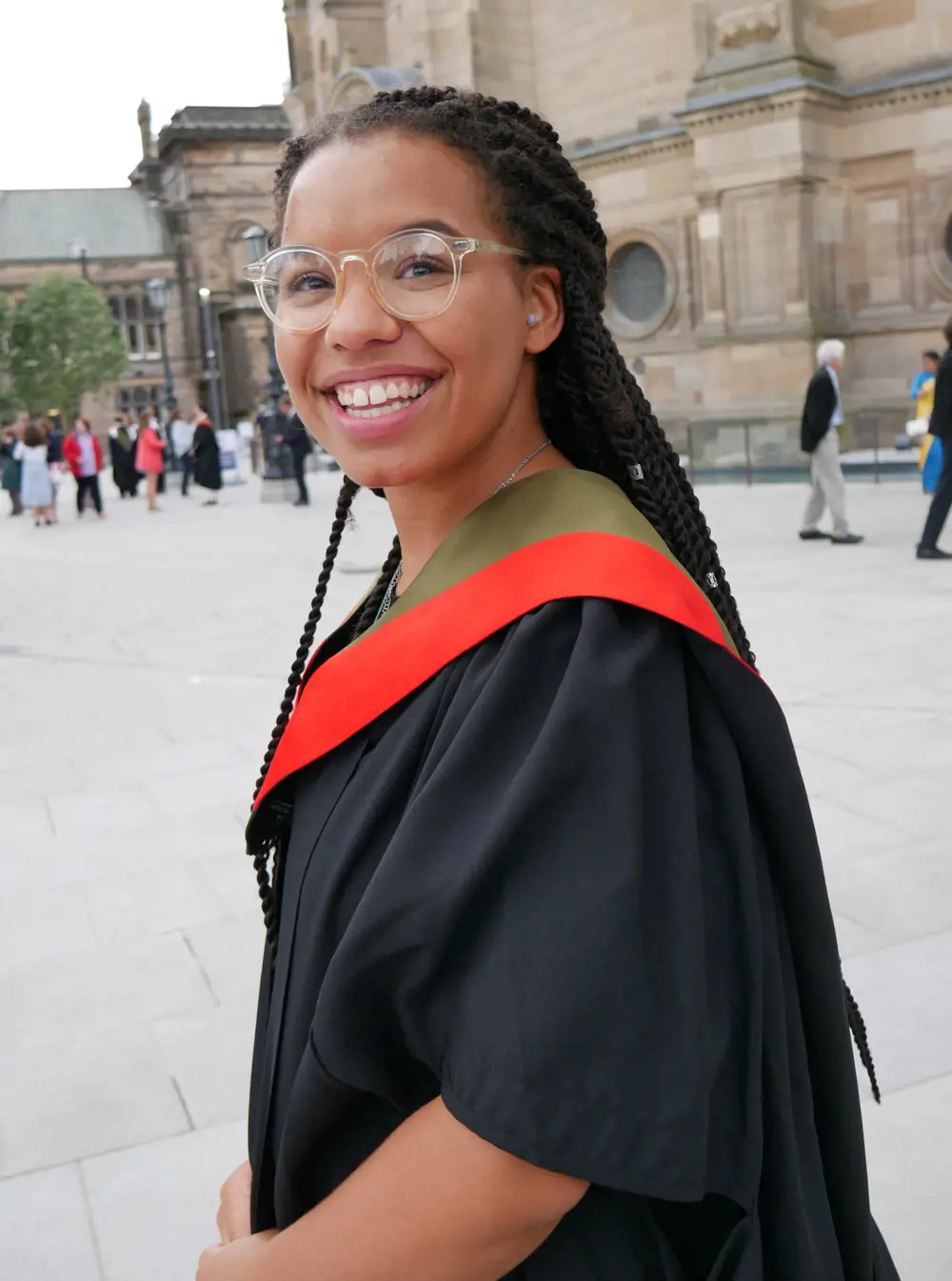 Olivia Sweeney in her graduation gown smiling.