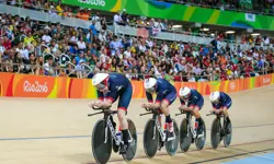 Four British Women's cyclists, cycling in a line in front of a crowd, in the velodrome at the Rio Olympics. 
