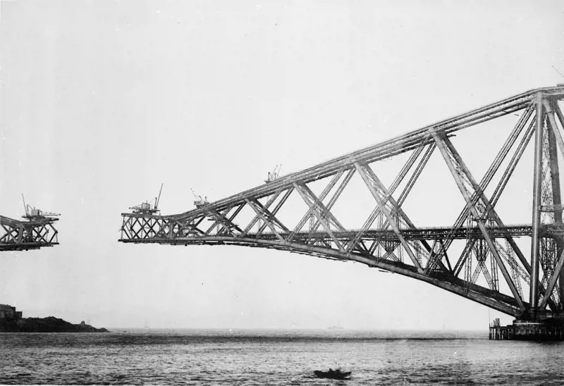 A bridge being constructed over water, with a gap in the middle.