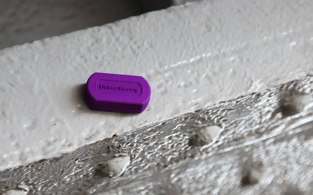 A small purple device that reads "Utterberry", sitting on a surface.