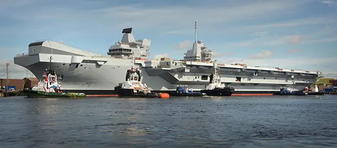 The HMS Queen Elizabeth parked at a dock. 