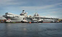 The HMS Queen Elizabeth parked at a dock.