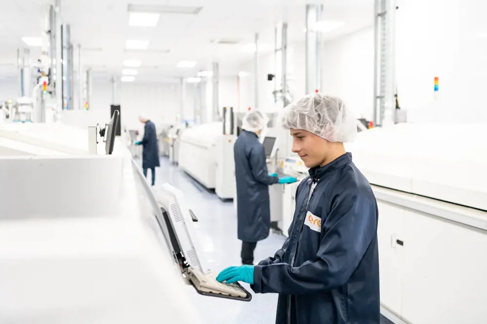 An apprentice typing on the interface of a machine at Ceres Power's Manufacturing Innovation Centre