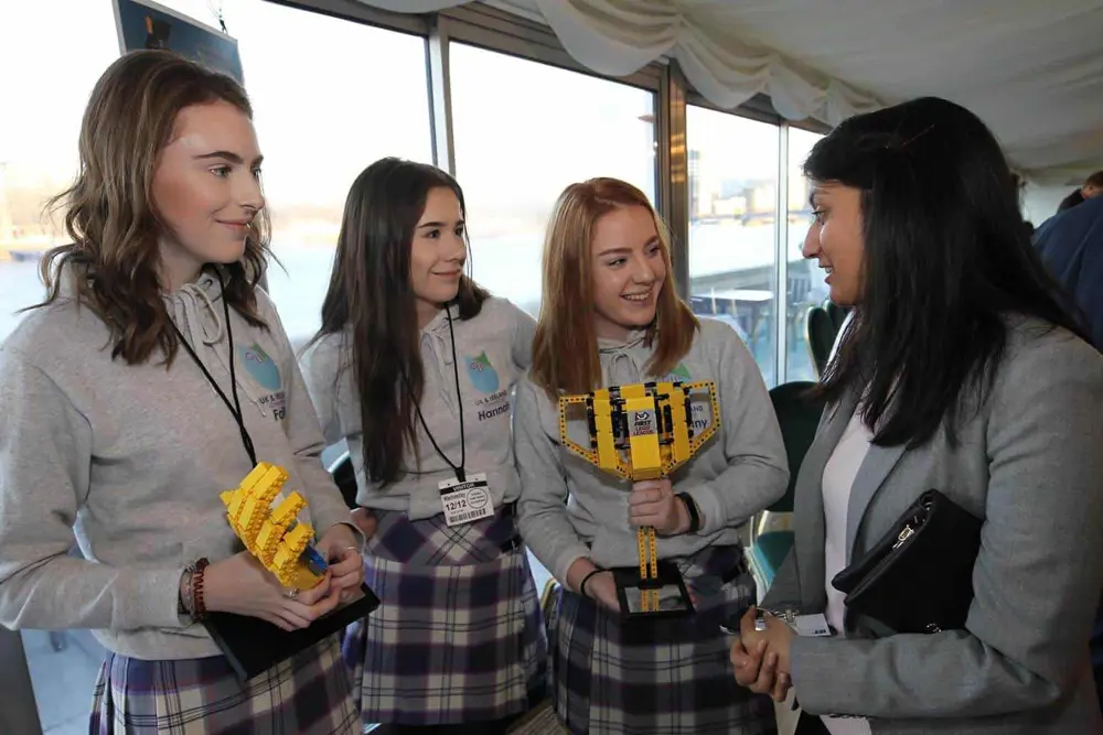 Mamta Singhal talking to three students.