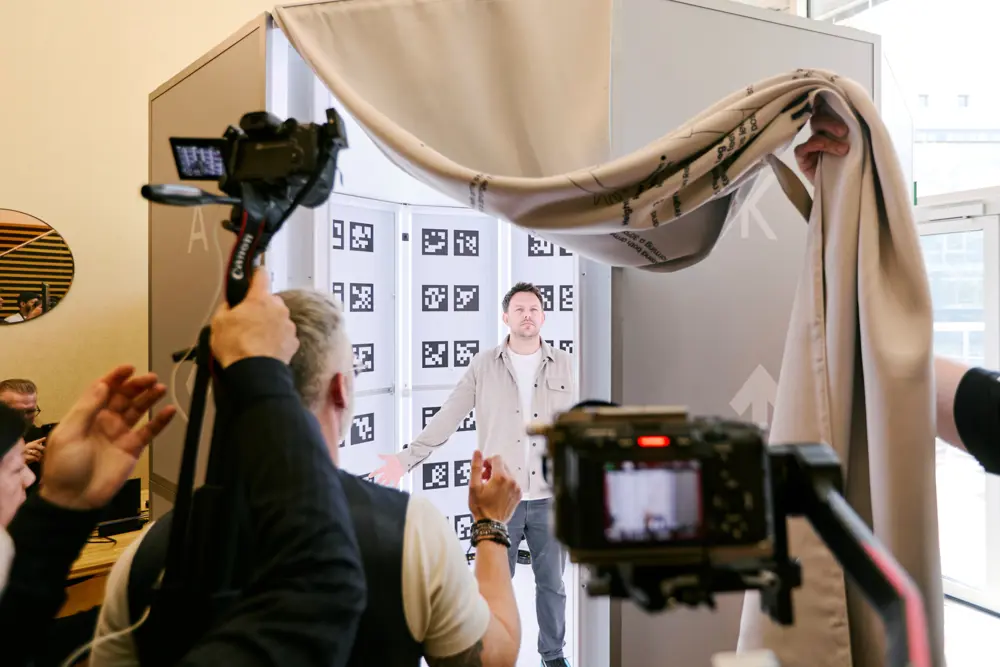 Filming setup with cameras and tracking markers capturing a person in a calibration booth for AI motion capture testing.