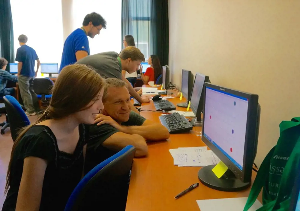 Professor Nick McKeown FREng with a female student looking at a computer screen.