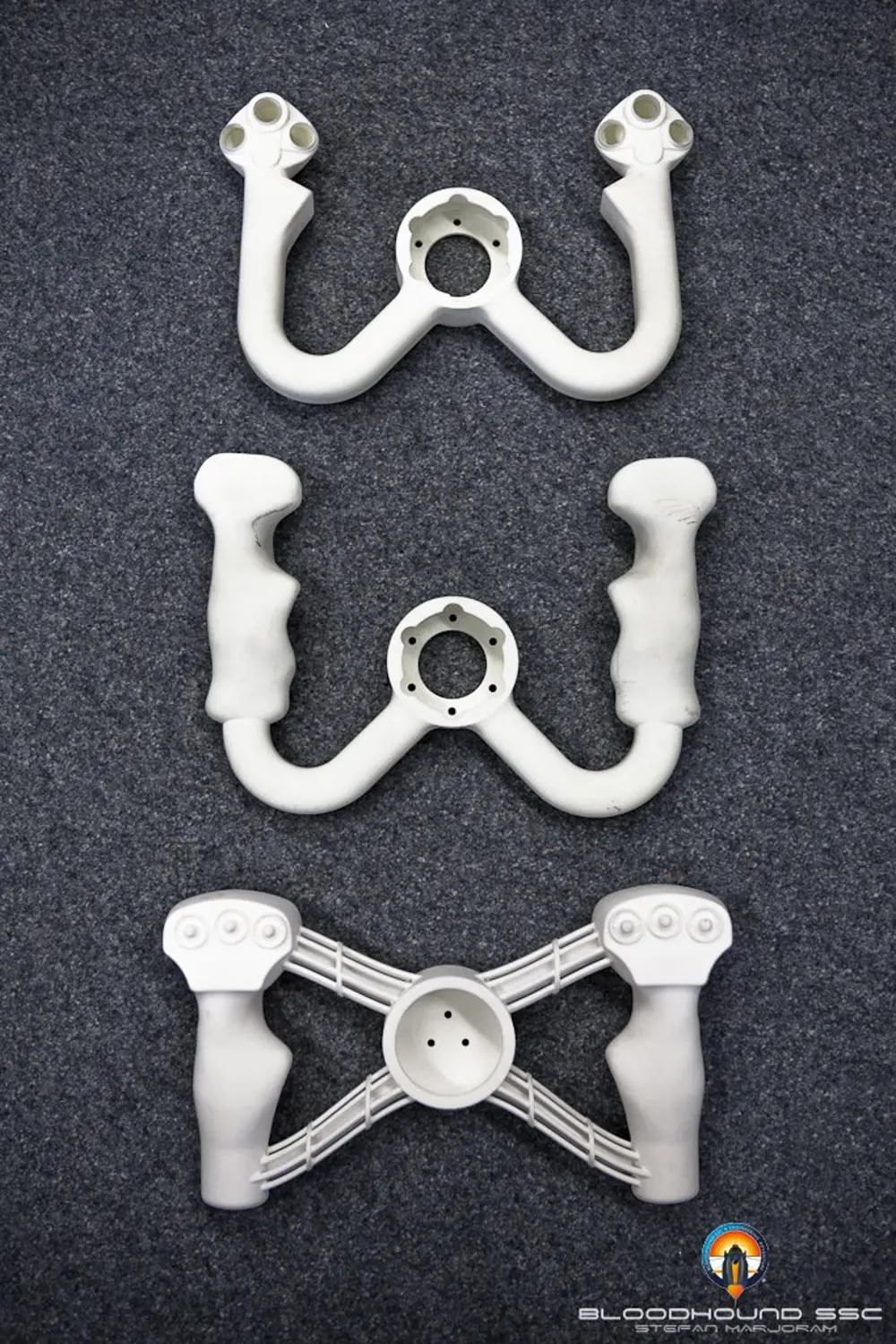 Three 3D-printed prototypes of the bloodhound's steering wheel.