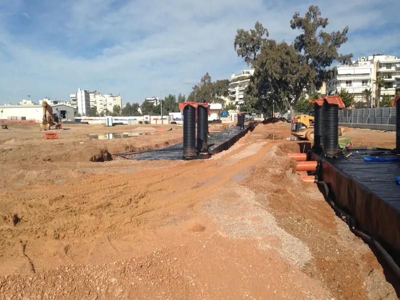A construction site with pipes and geocellular tanks.