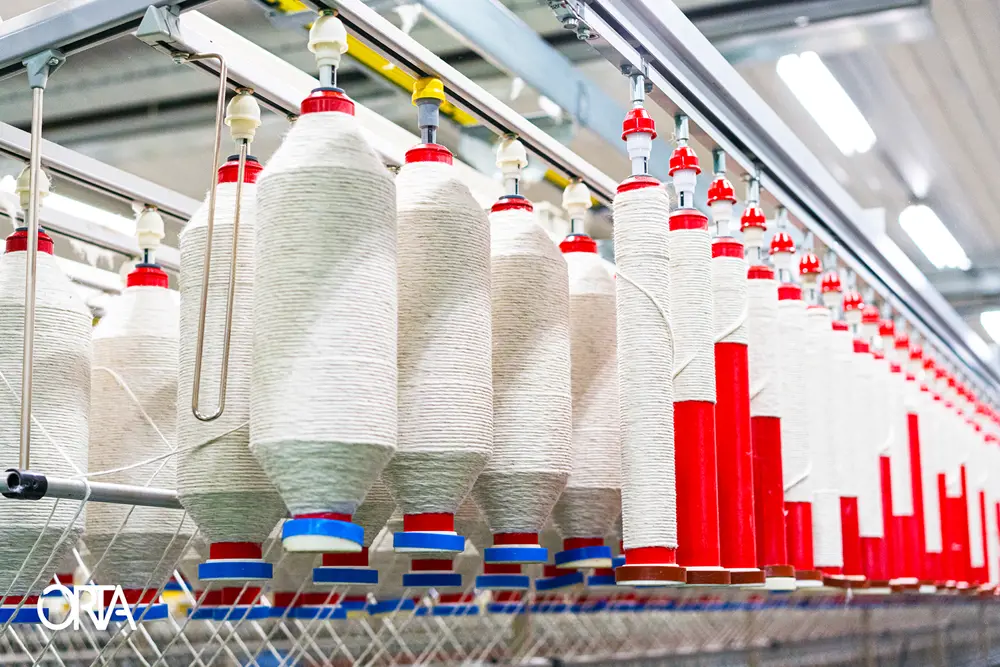 An array of spools of spun cotton, as part of making jeans