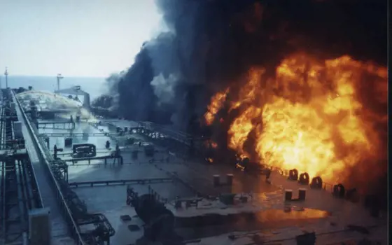 An explosion next to a large ship.