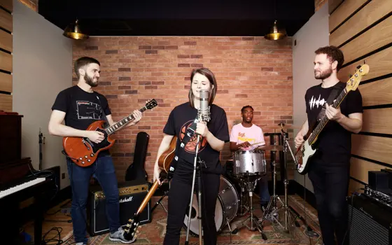 A band performing in a studio. 