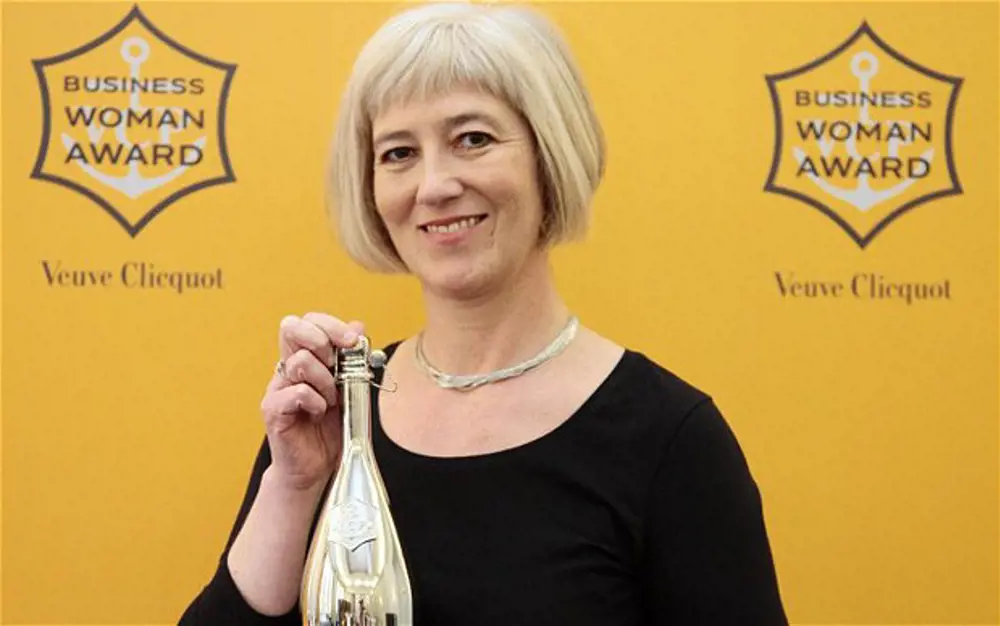 Michelle McDowell holding the woman of the year award.