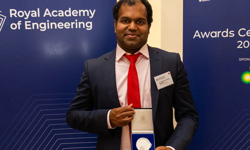 Dr Sabesan Sithamparanathan standing with the Sir George Macfarlane medal, at the Royal Academy of Engineering awards ceremony. 