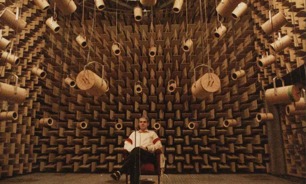 A person sitting in an anechoic chamber.