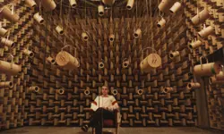 A person sitting in an anechoic chamber.