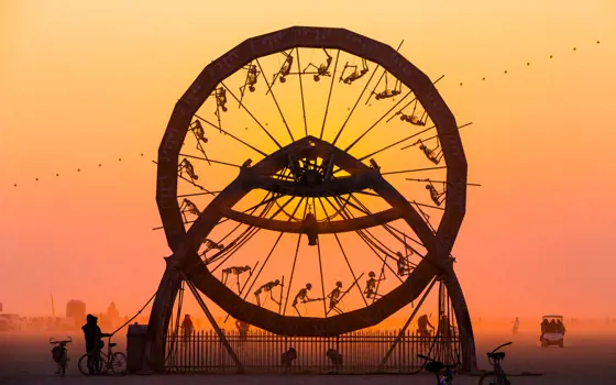 The Charon Zoetrope is pictured against a red sky, with all of its skeletons around the edge visible in silhouette form.