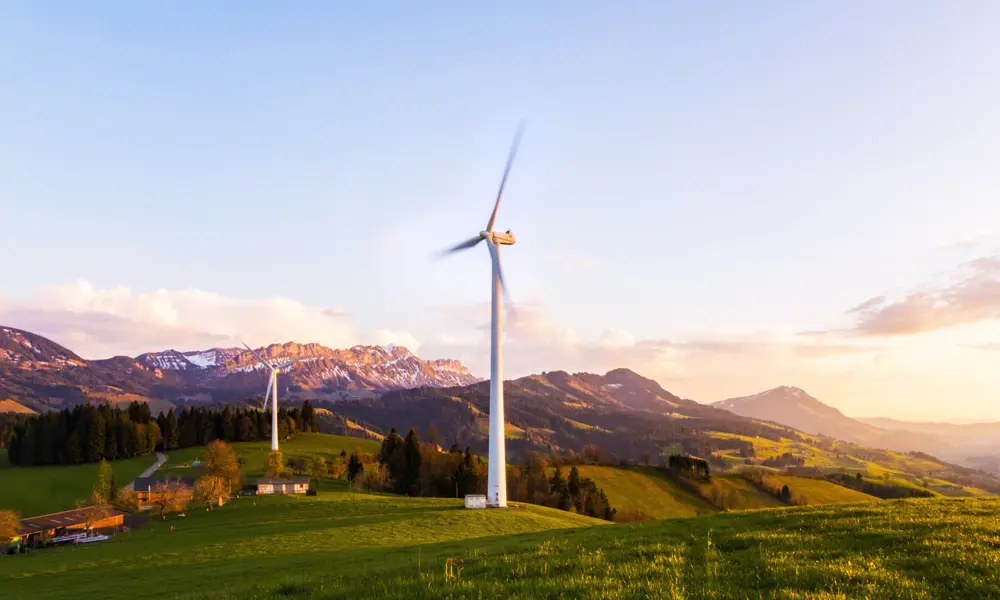 A wind turbine on a hillside in the mountains