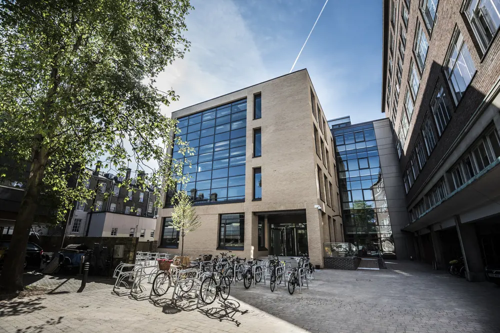 The outside of the Dyson Centre for Engineering Design on a sunny day.