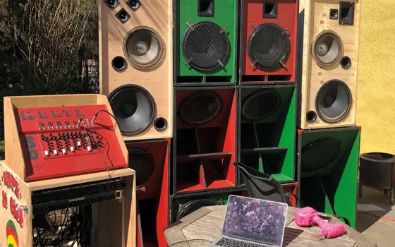 A soundsystem made from wood, painted red and green with "Hertz So Good" on the side.