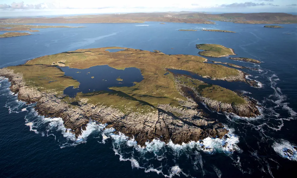An aerial shot of an island in the ocean. 
