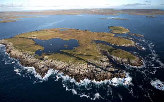 An aerial shot of an island in the ocean. 