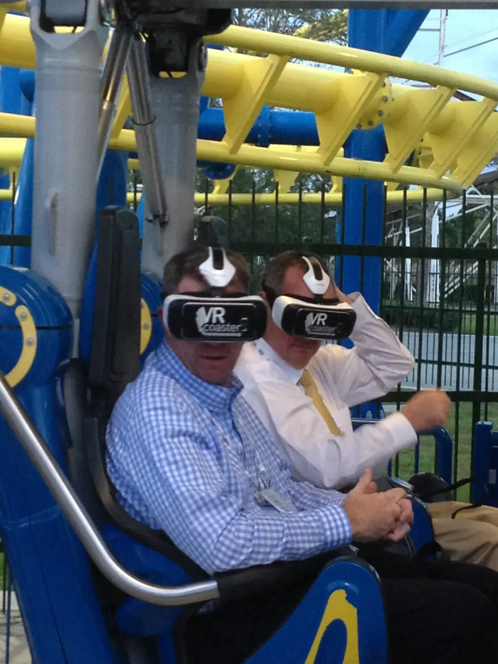Two people on the Suspended Family Coaster Freedom Flyer VR coaster wearing VR headsets. 
