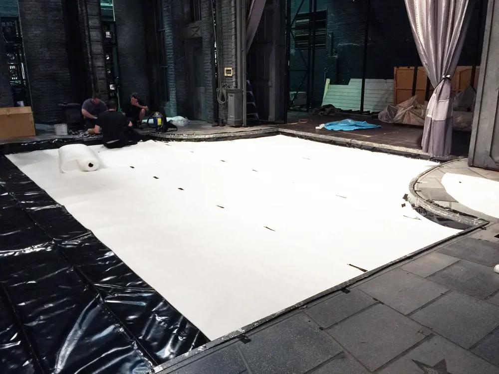 The pool area, revealing the correx floor and PVC-coated fabric that sits under the decking and the stainless steel frame surrounding the area.