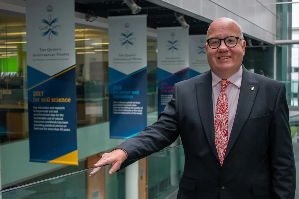 Professor Simon Pollard standing in a university research department.