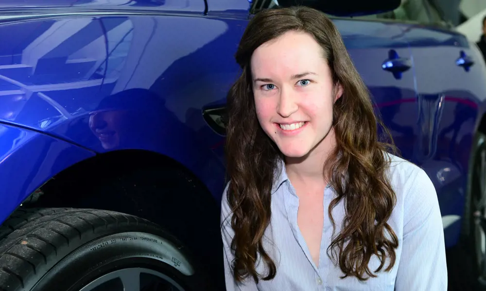 A headshot of Orla Murphy next to a blue car. 