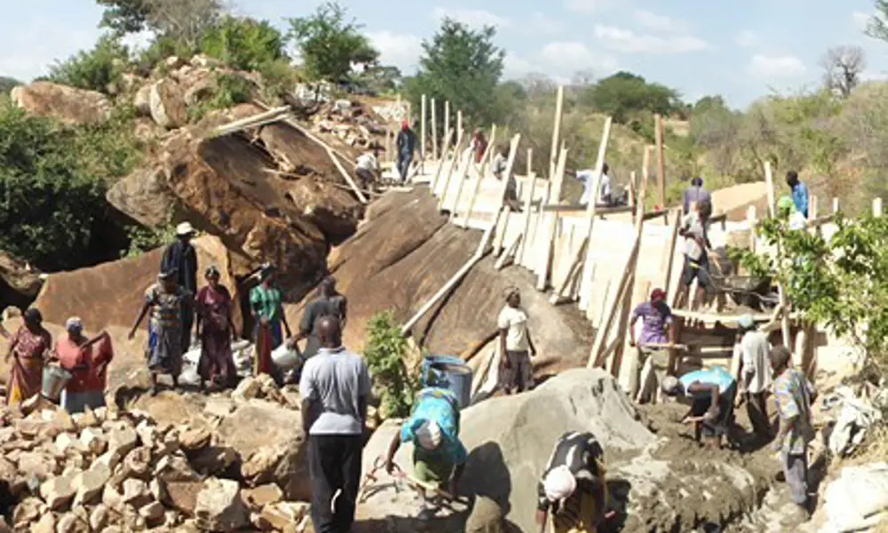 A group of people constructing a sand dam in Kenya.