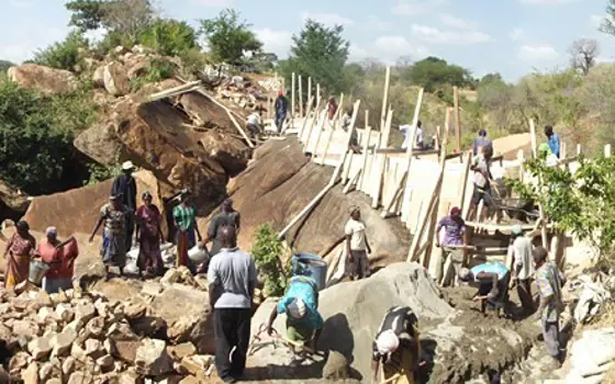 A group of people constructing a sand dam in Kenya.