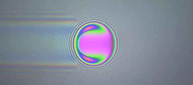 Coloured optical interference fringes around a ball.
