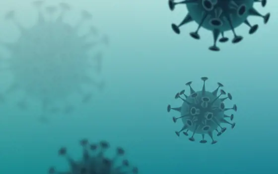 An illustration of floating circular virus particles with long spikes on the outside.
