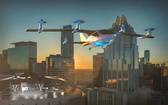 An electric plane taking off in a city from a helicopter landing pad.