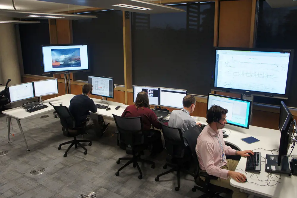 Four people working at desks in the Emergency Response Centre at the University of Southampton.