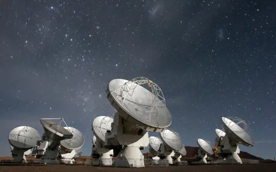 The ALMA antennas at night.