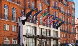 The front of Claridge's hotel, with flags such as the British, Irish and American flag hung above the entrance. 