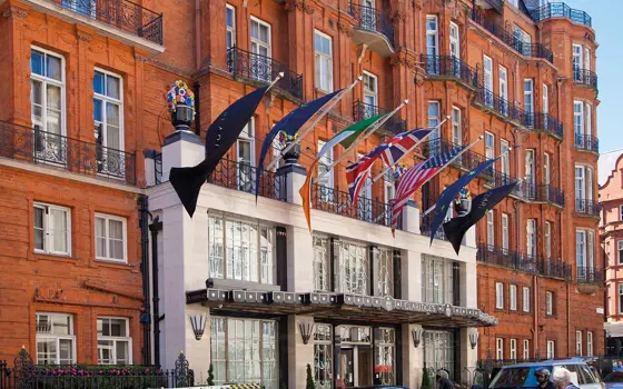 The front of Claridge's hotel, with flags such as the British, Irish and American flag hung above the entrance. 