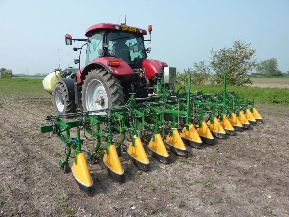 A base sprayer attached to a tractor. 