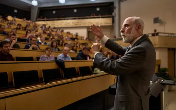 Vint Cerf standing in front of a room of people in a lecture hall.