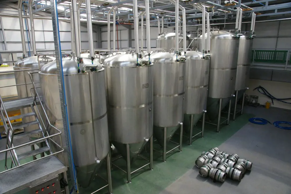 Metal brewing tanks in a factory. 