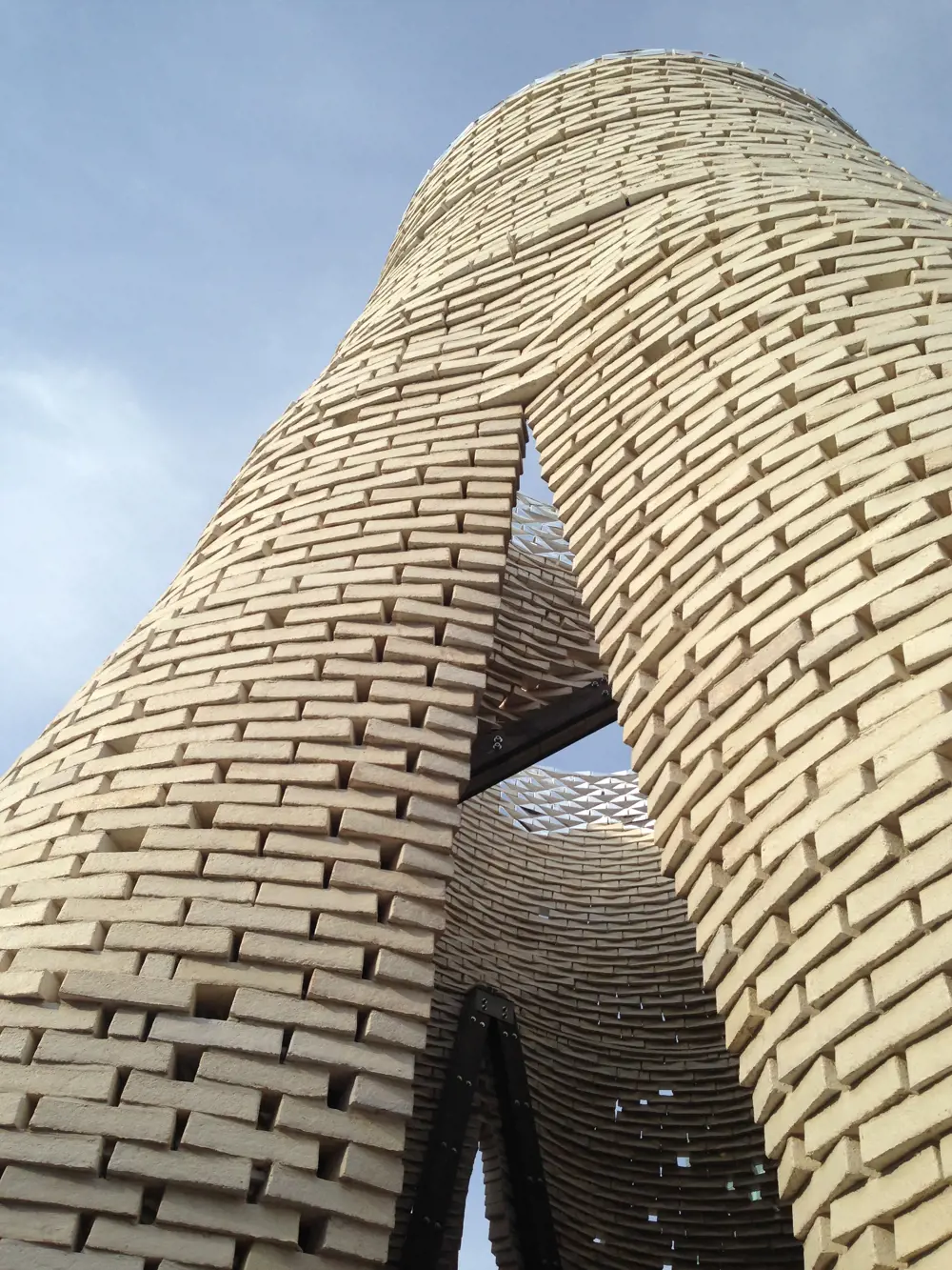 A tower made of white blocks of mycelium, seen from below.