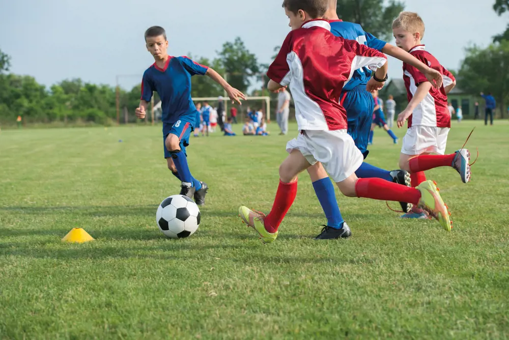 A group of children playing football.