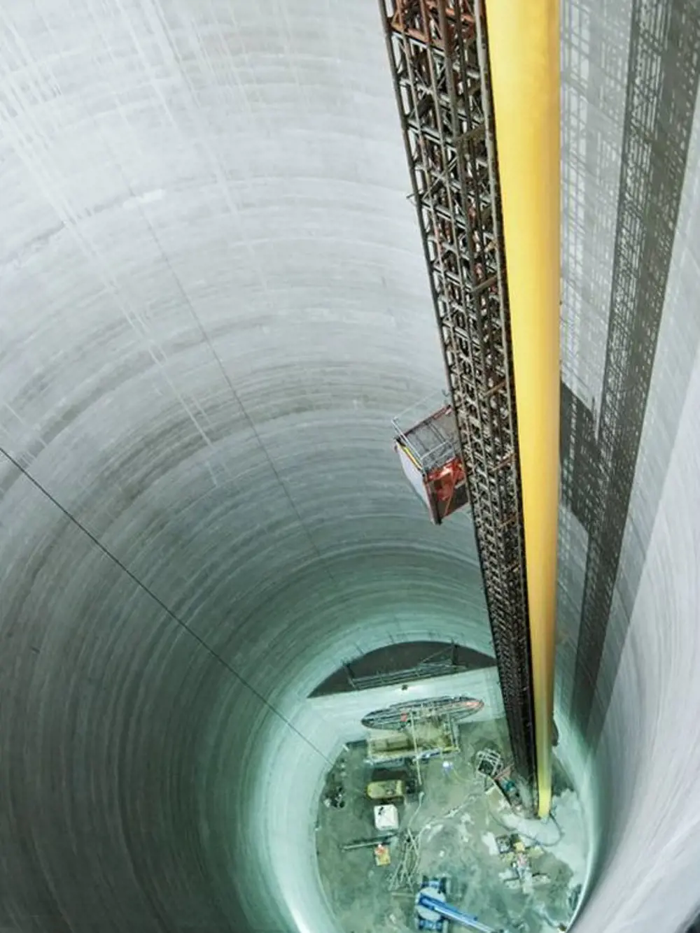 A view downwards into the inside of a deep tunnel shaft.