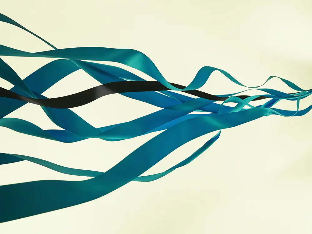 Several blue ribbons are blown into the distance