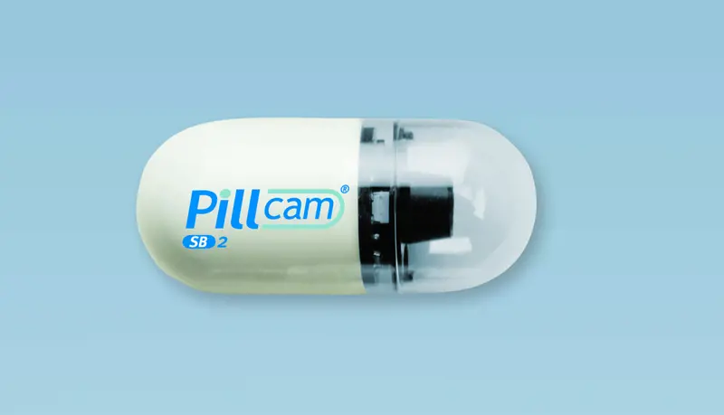 A pill-shaped camera with the Pillcam logo written on it. 