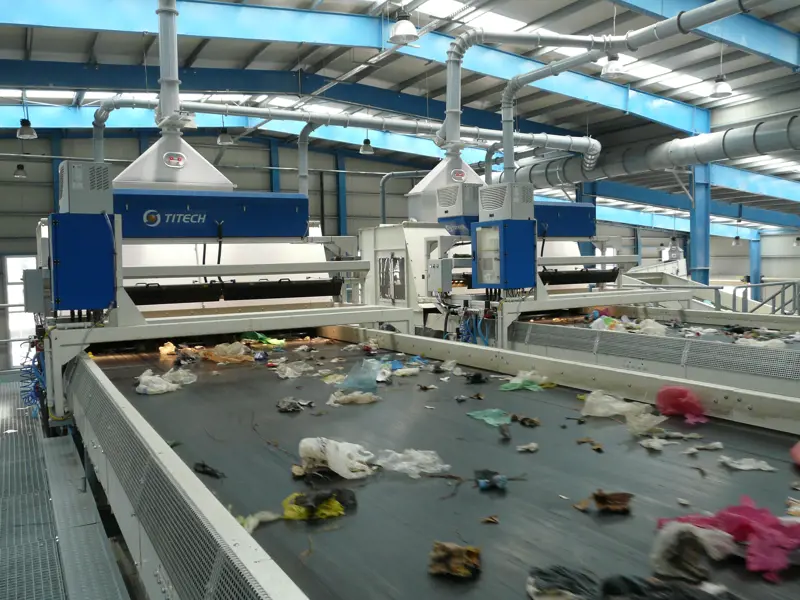 Waste on a conveyor belt being sorted by infrared separators.
