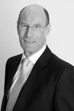 A greyscale headshot of Sir John Armitt.