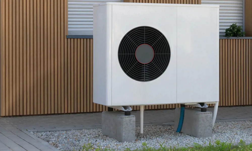 A ground air source heat pump outside of a building. 